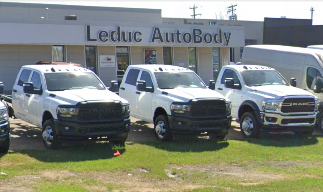 Exterior of Leduc Auto Body shop with repaired vehicles